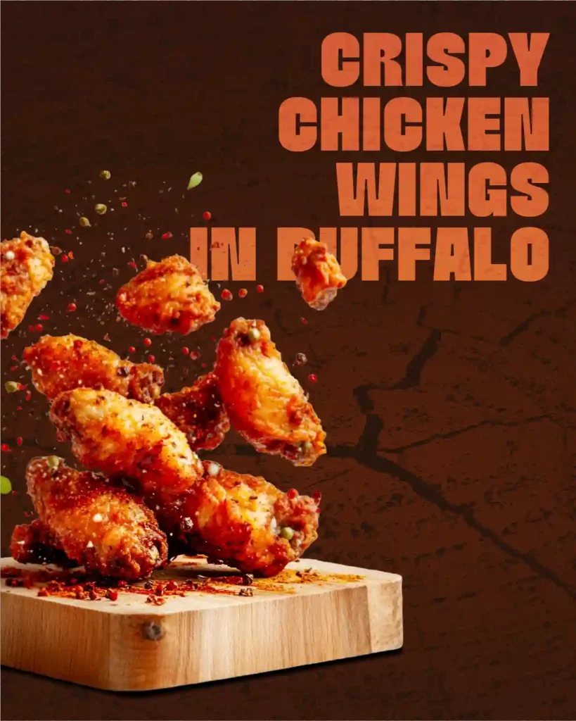 Crispy buffalo chicken wings seasoned with spices on a wooden serving board.
